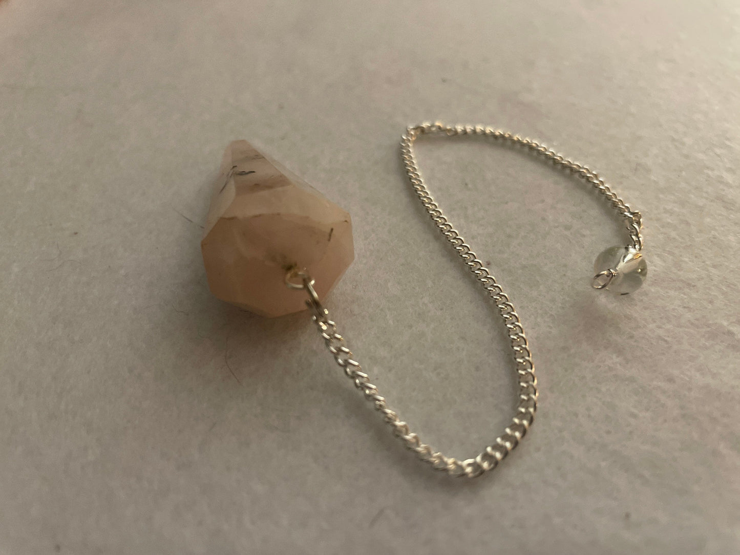 This beautiful Rose Quartz Pendulum is  1.65” and with chain is 8.25”