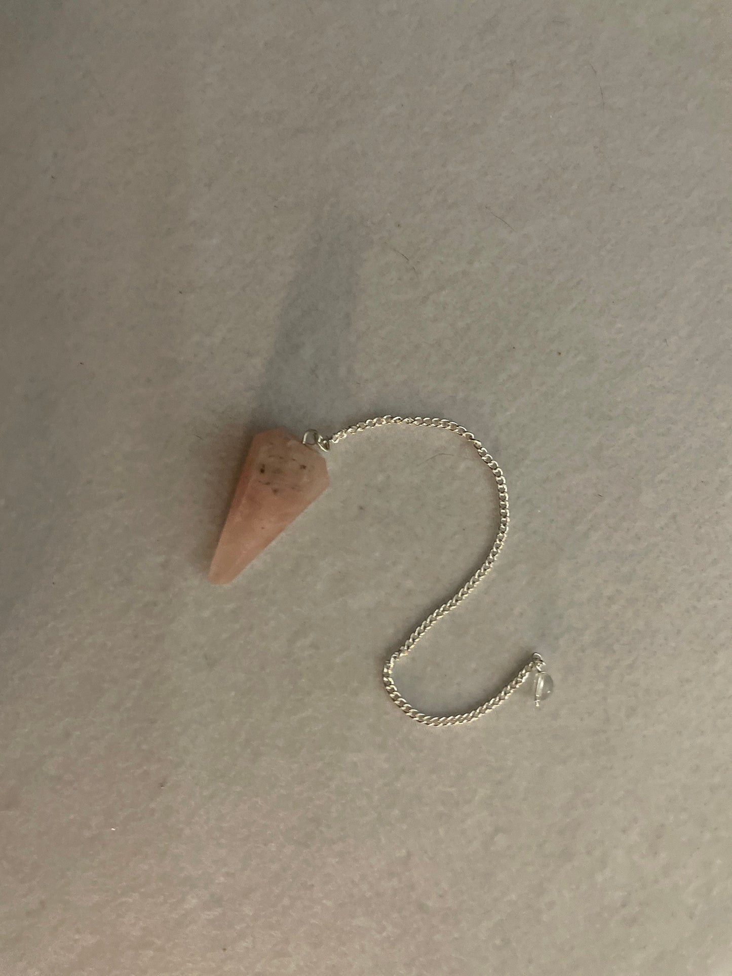 This beautiful Rose Quartz Pendulum is  1.5” and with chain is 8”