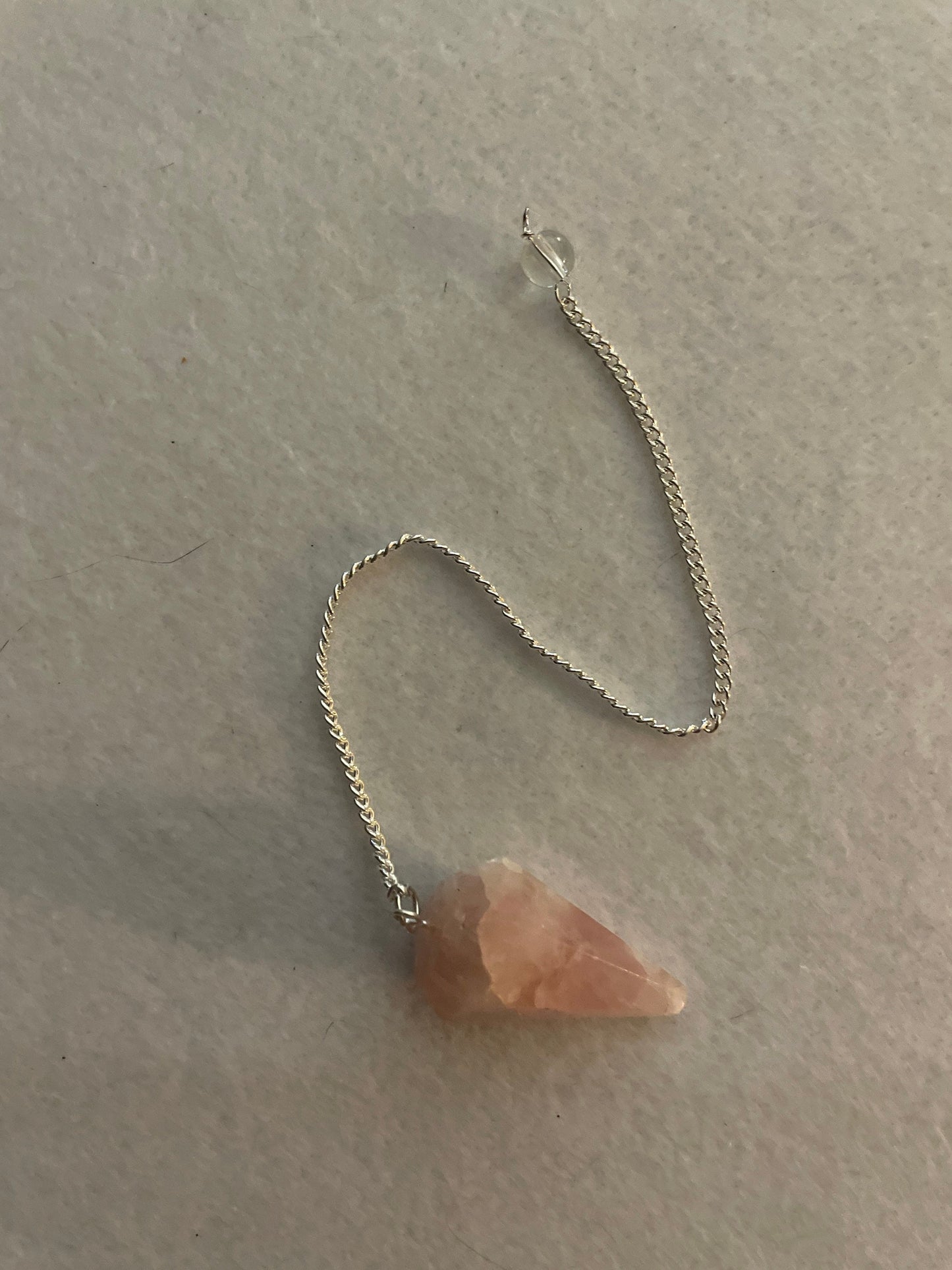 This beautiful Rose Quartz Pendulum is  1.35” and with chain is 8”