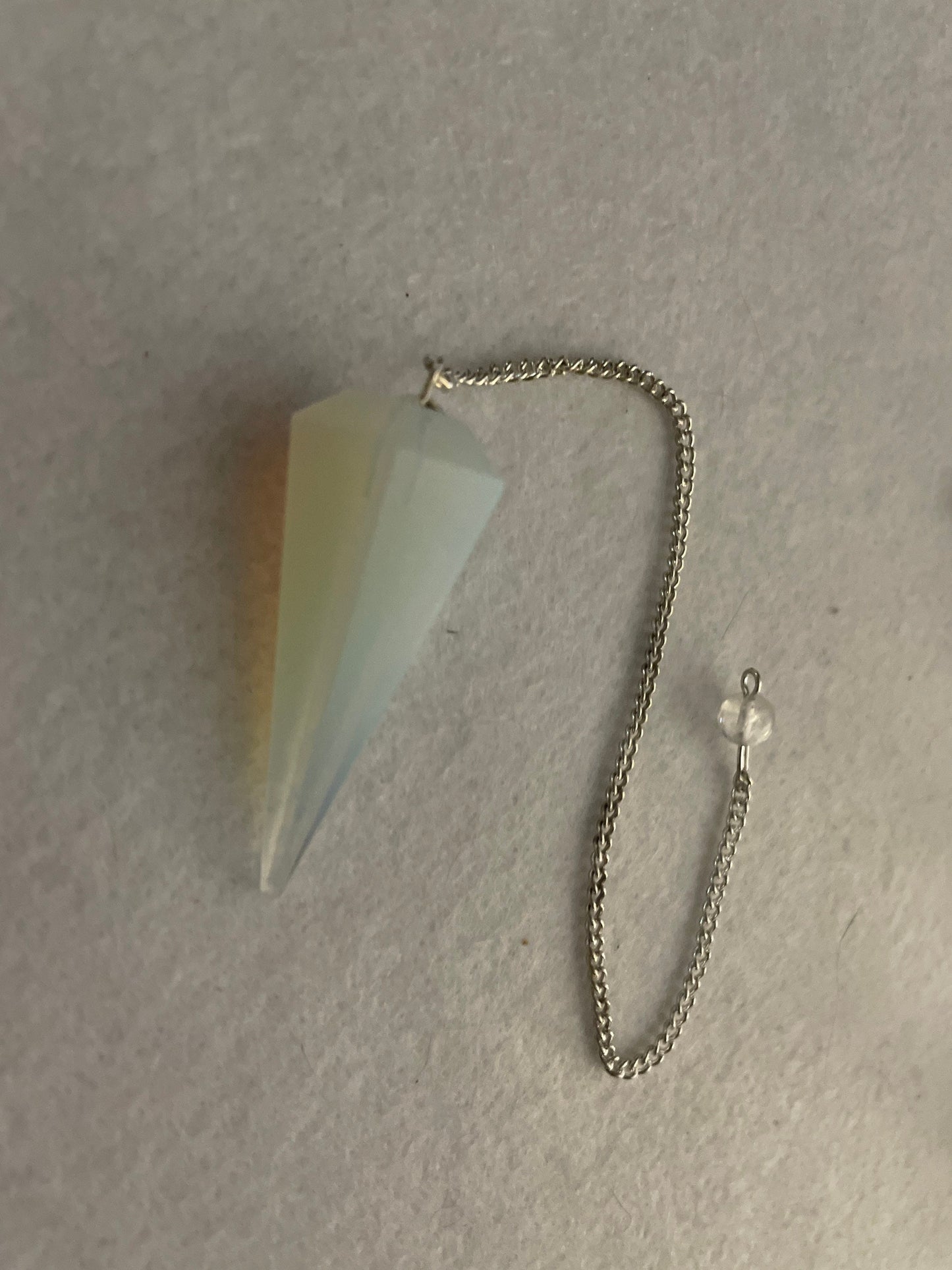 This beautiful Opalite Pendulum is  1.75” and with chain is 8.50”