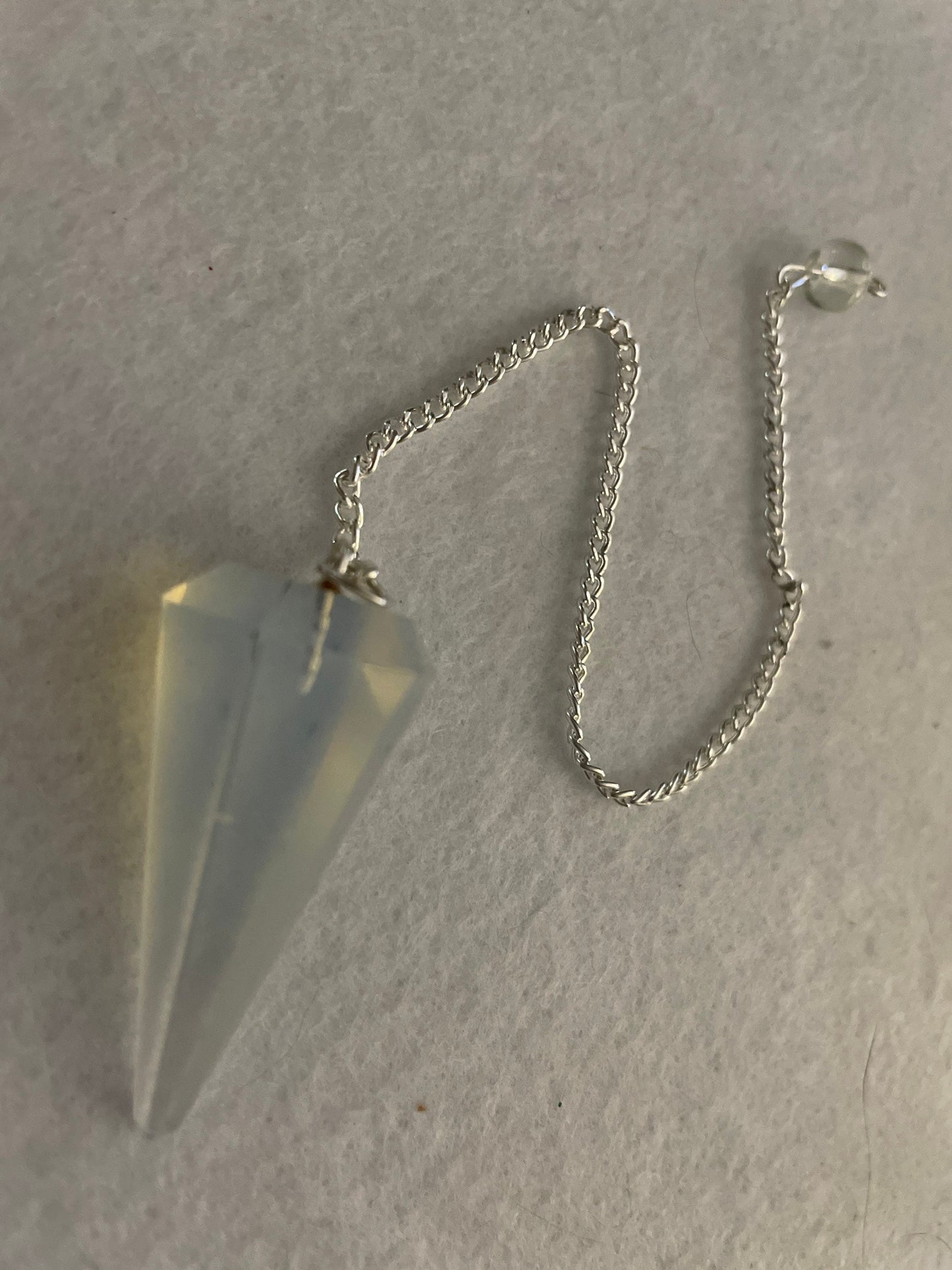 This beautiful  Opalite pendulum is approximately 1.5” and with chain is 8.25”