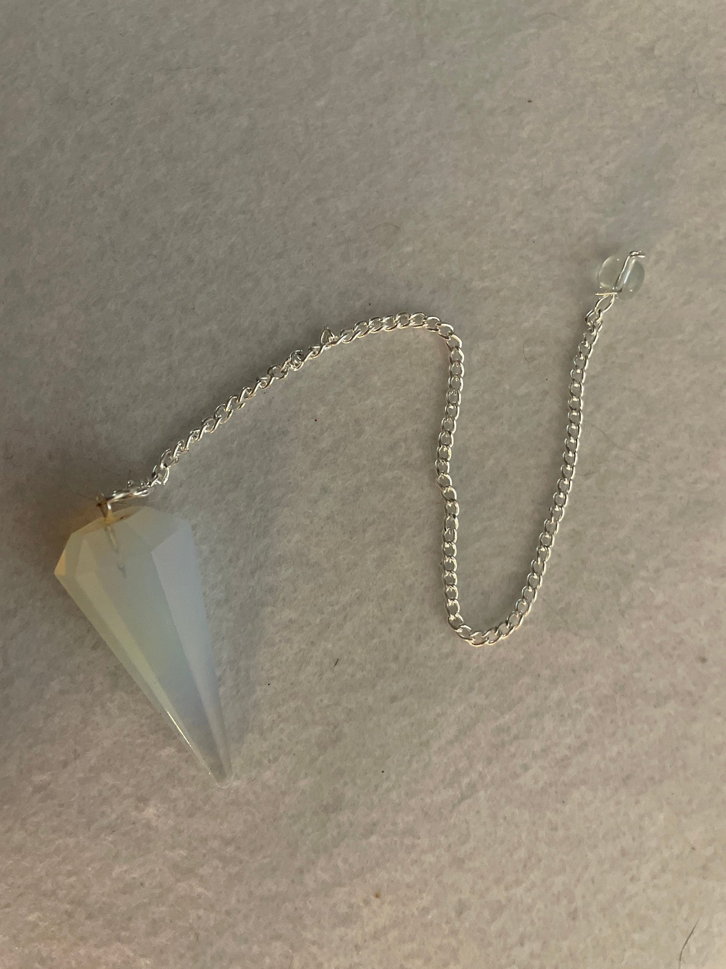 This beautiful  Opalite pendulum is approximately 1.65” and with chain is 8.5”