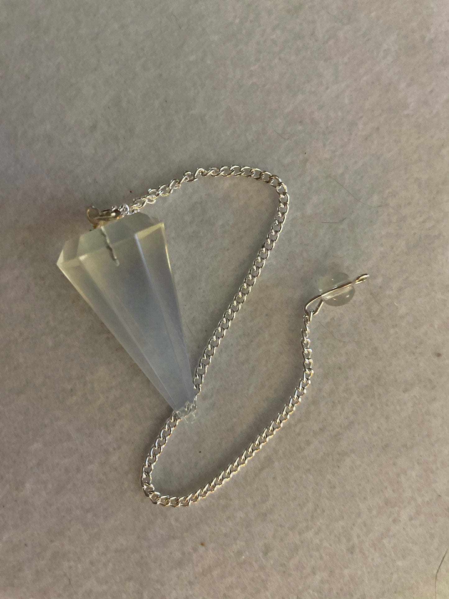 This beautiful  Opalite pendulum is approximately 1.65” and with chain is 8.5”