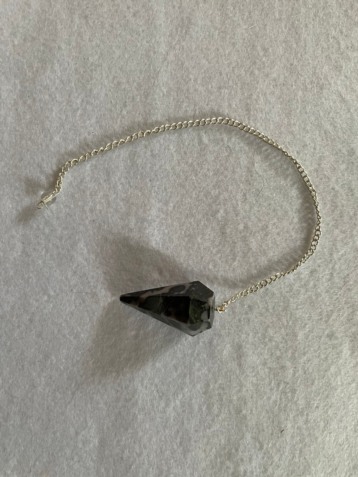 This beautiful Gabbro pendulum is approximately 1.5” and with chain is 9.5” total length.