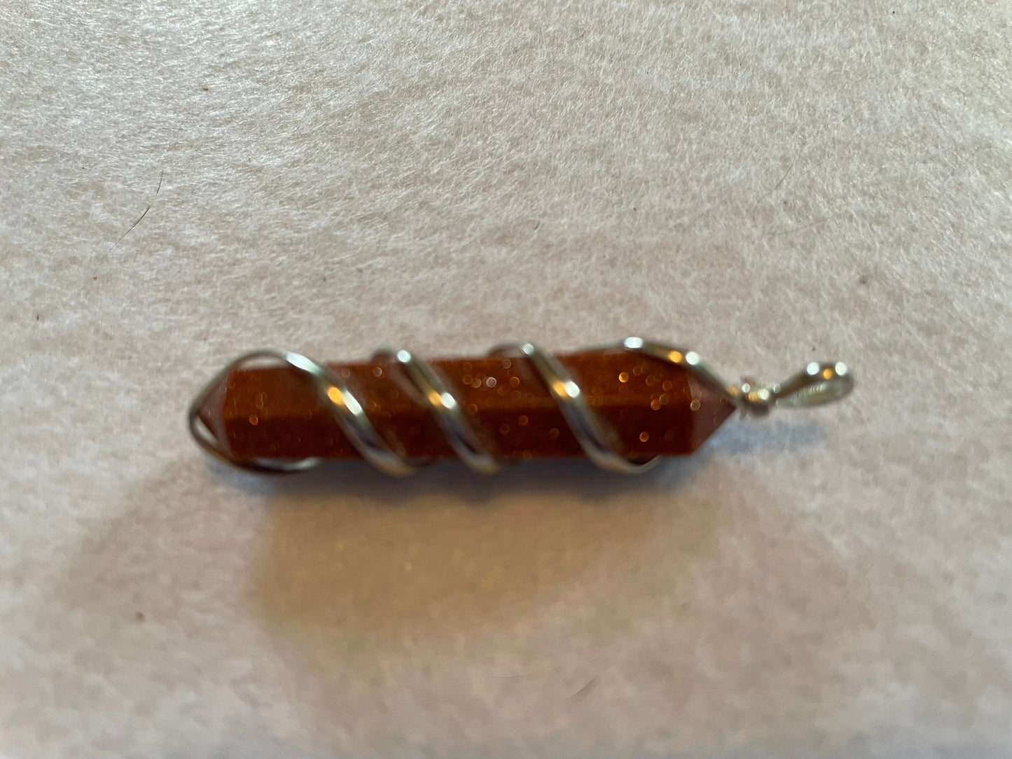 Gorgeous Goldstone Point Pendant is  1.5”