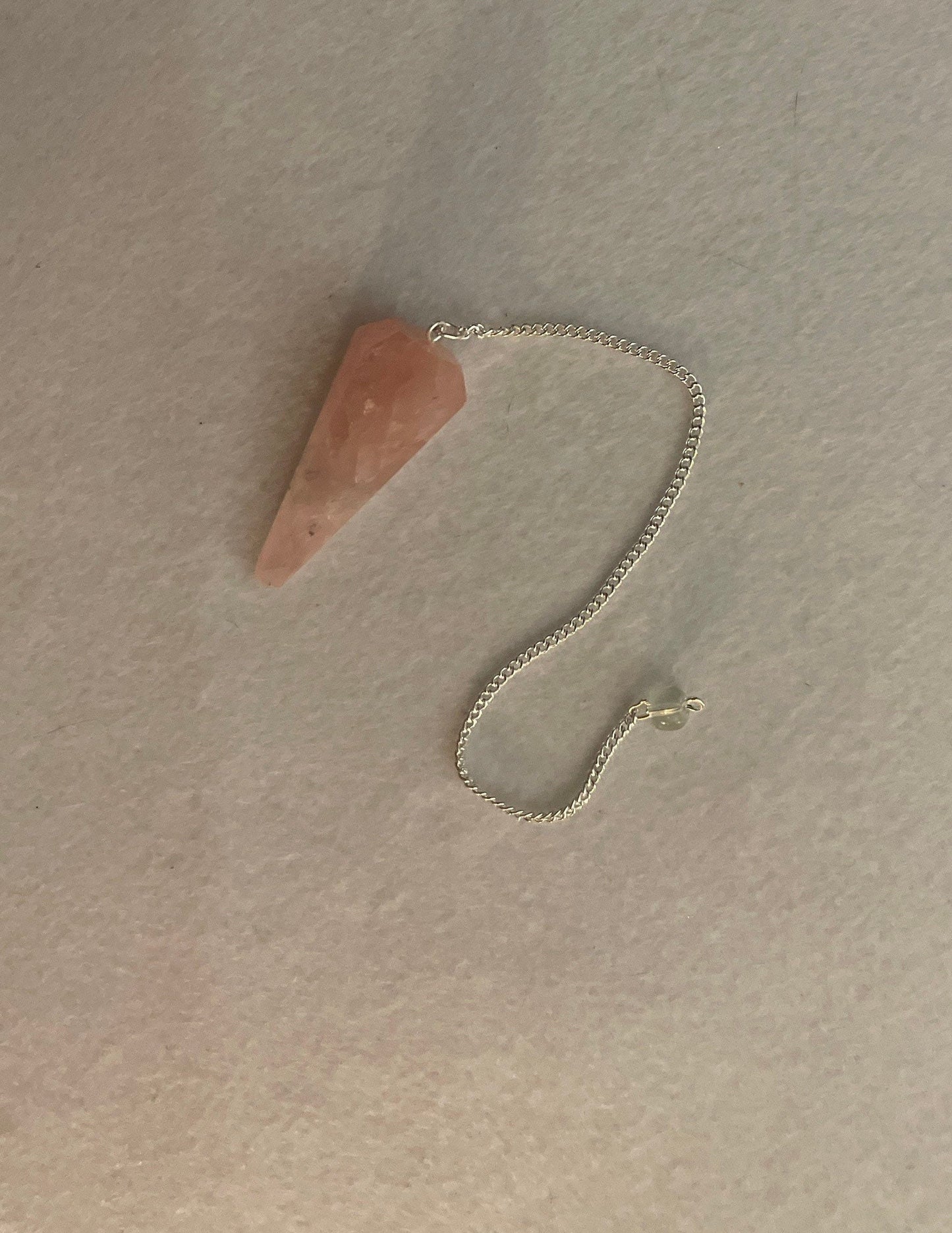 This beautiful Rose Quartz Pendulum is  1.85” and with chain is 8.25”