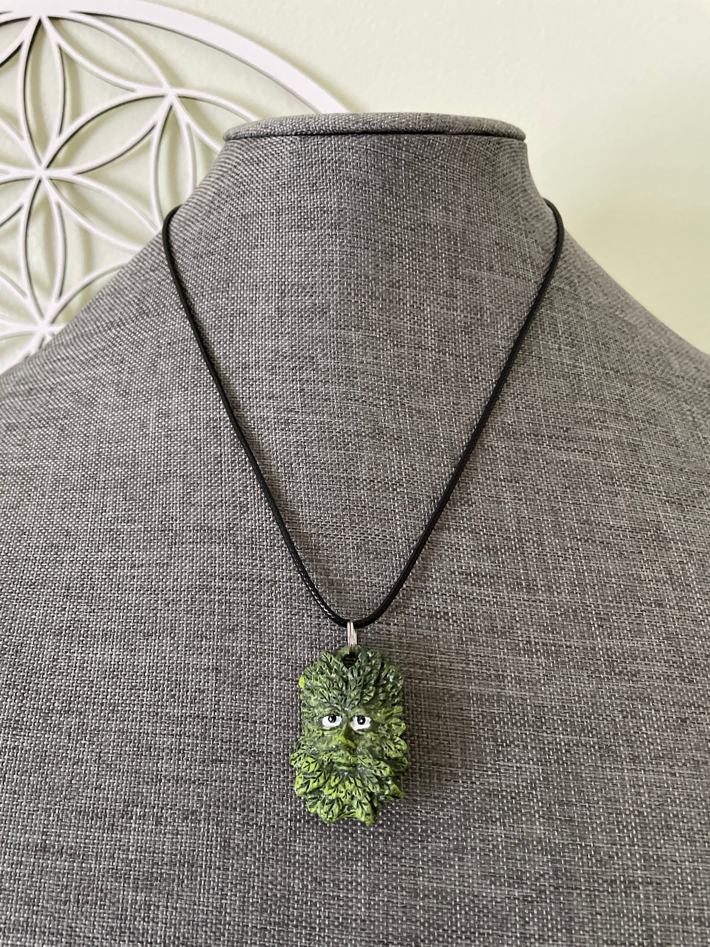 Greenman pendant necklace on black cord.