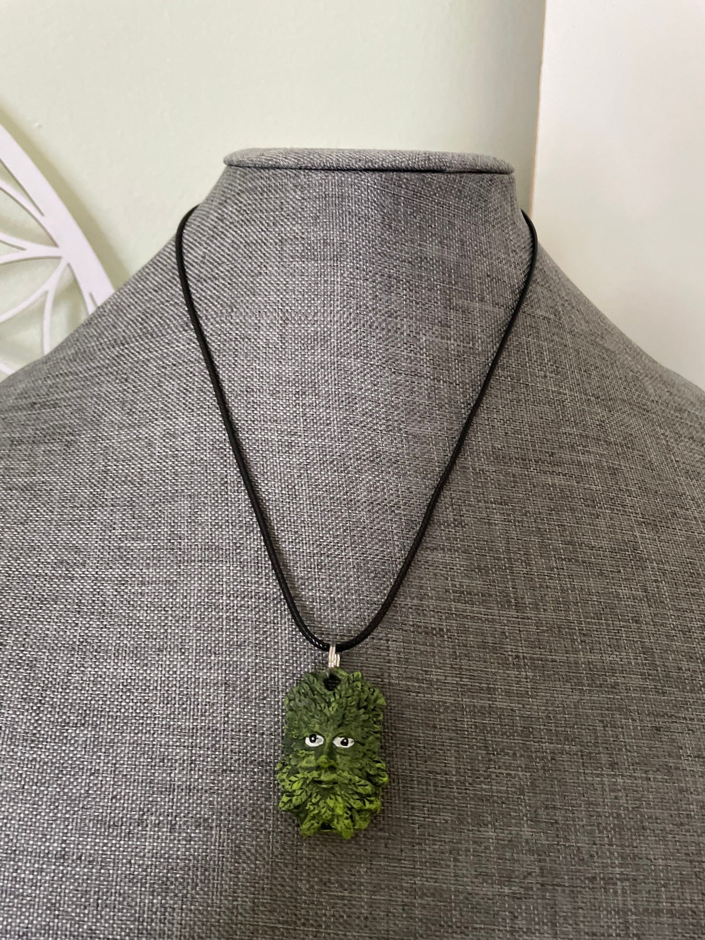 Greenman pendant necklace on black cord.