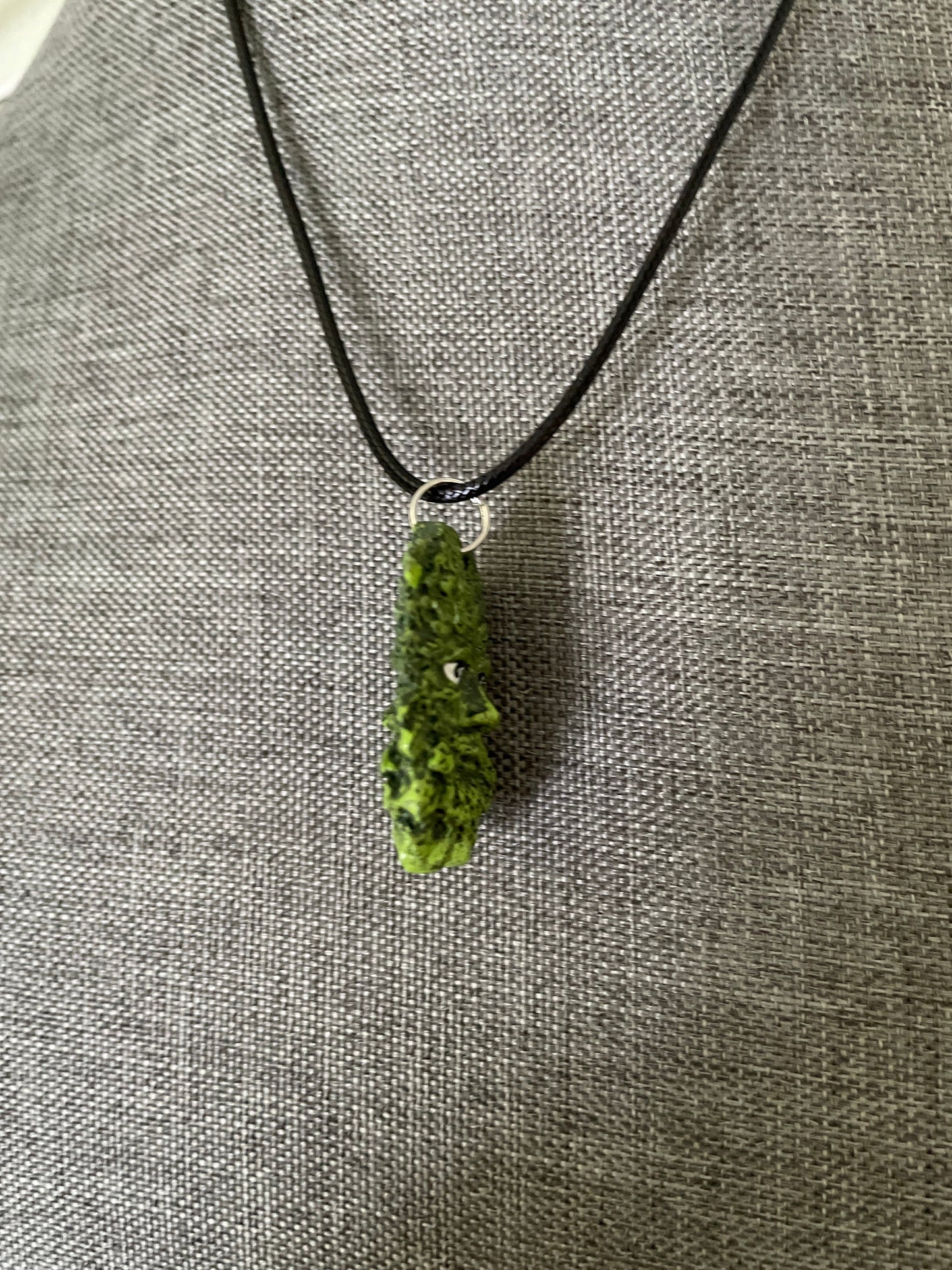 Greenman pendant necklace on black cord.