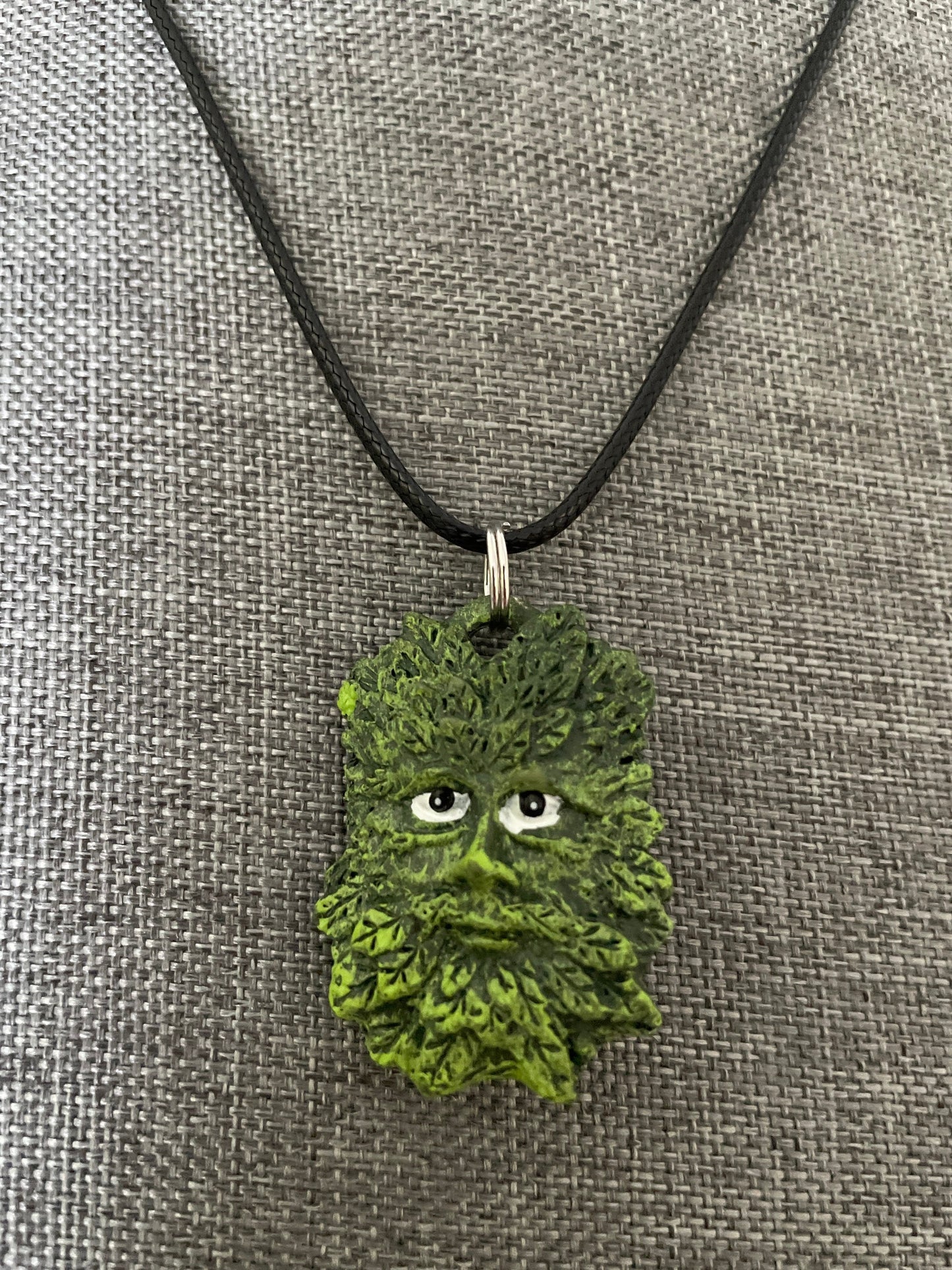 Greenman pendant necklace on black cord.