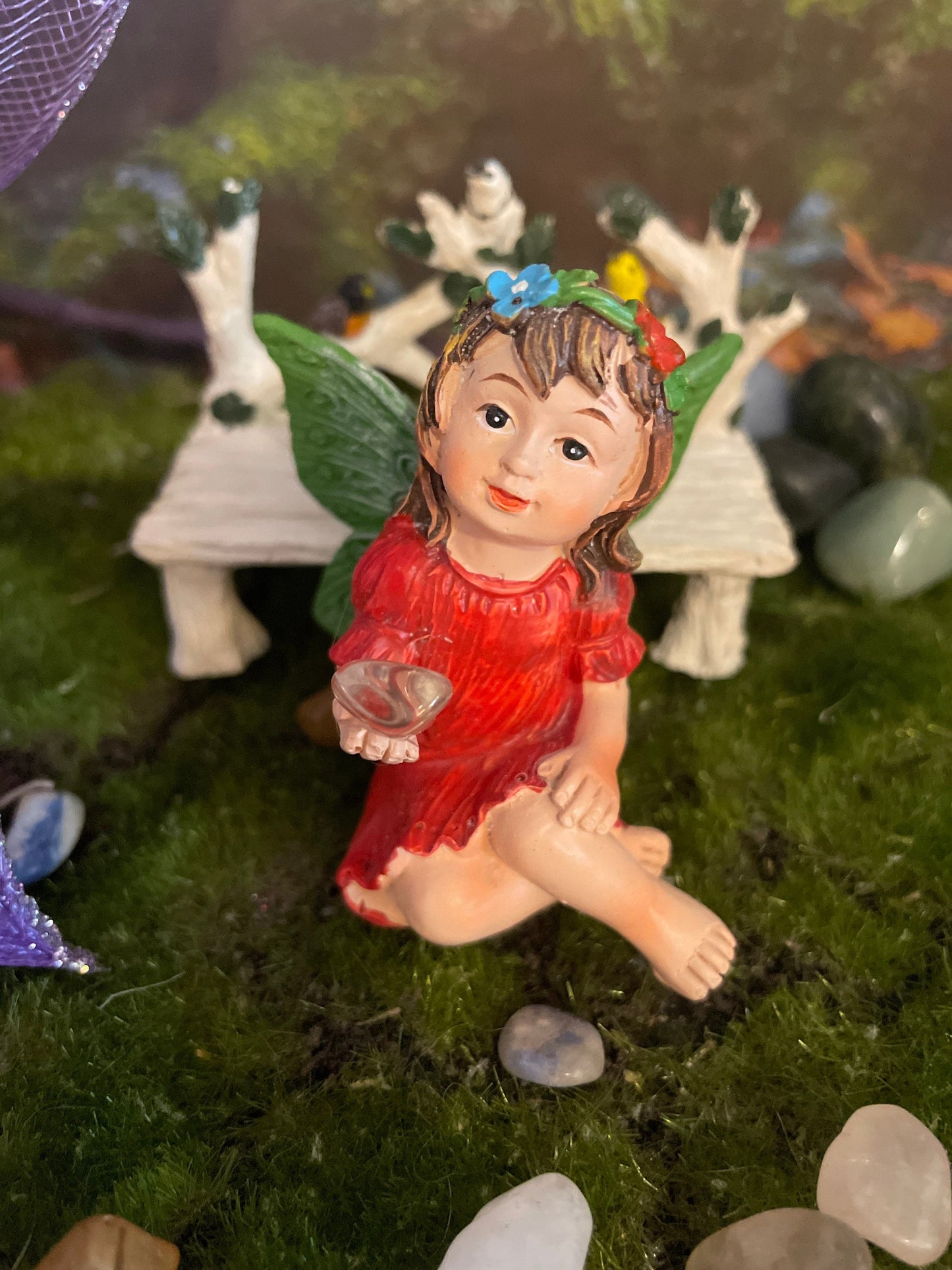 Look at her sweet face and she’s holding a clear quartz crystal hand-painted fairy with crystals